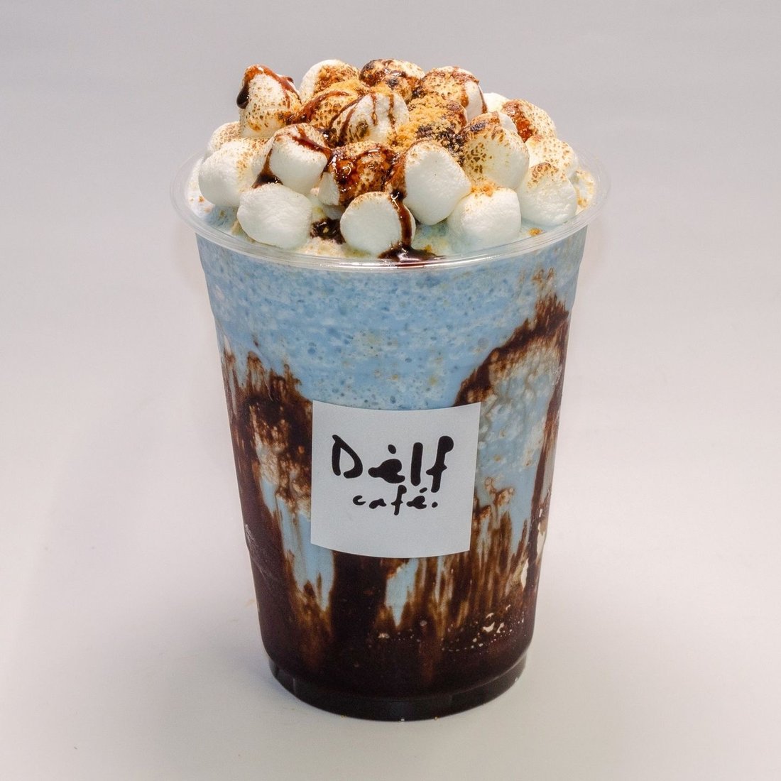 Blue s'mores frappe topped with toasted marshmallows and chocolate drizzle at Dèlf Café